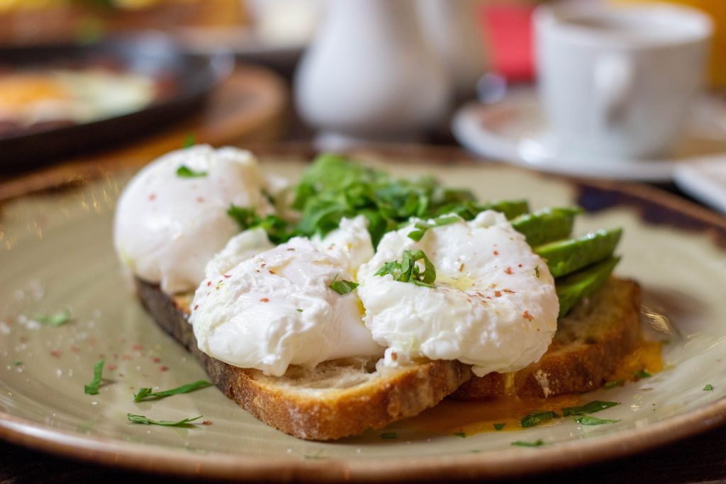Easy egg recipes.
A medium shot of avocado and egg on top of sourdough toast.